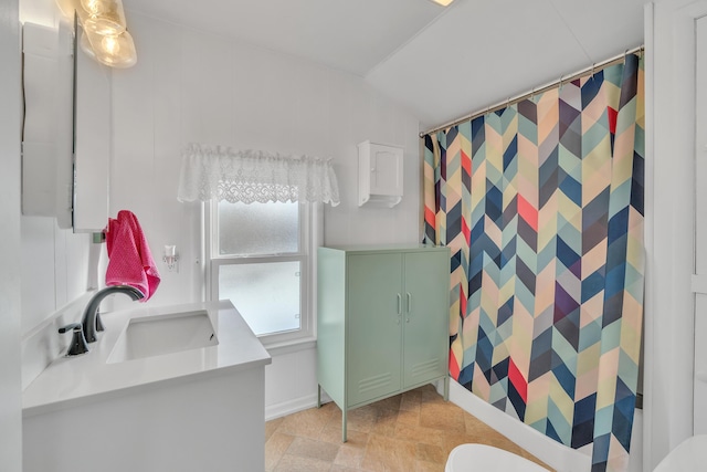 bathroom with curtained shower and vanity