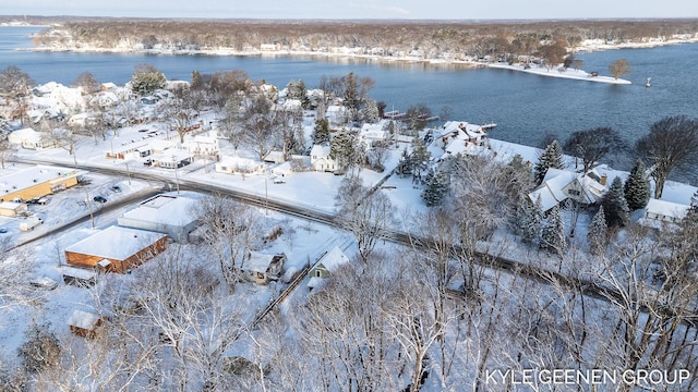 snowy aerial view featuring a water view