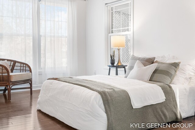 bedroom with dark wood-type flooring