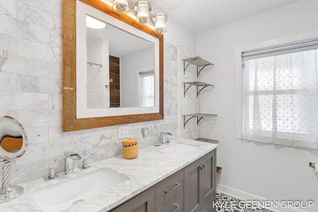 bathroom featuring plenty of natural light, decorative backsplash, and vanity