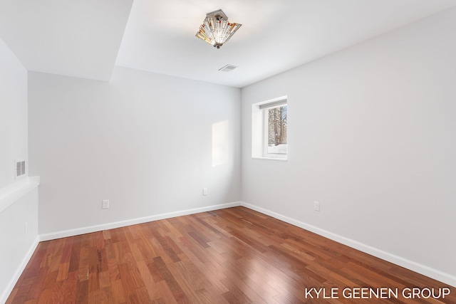 unfurnished room with hardwood / wood-style floors