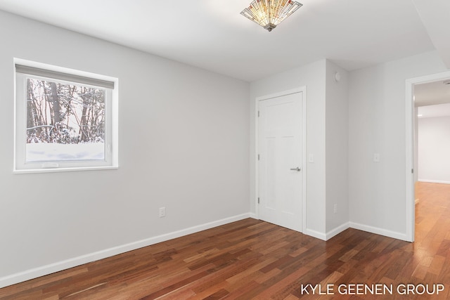 unfurnished bedroom with dark hardwood / wood-style flooring