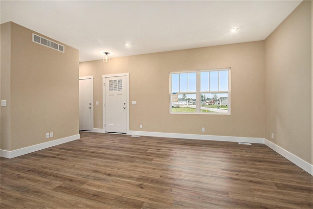 unfurnished room with dark hardwood / wood-style flooring