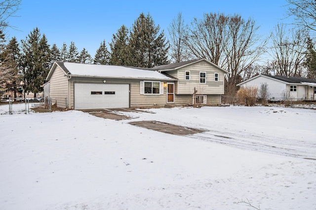 view of front of house with an attached garage and fence