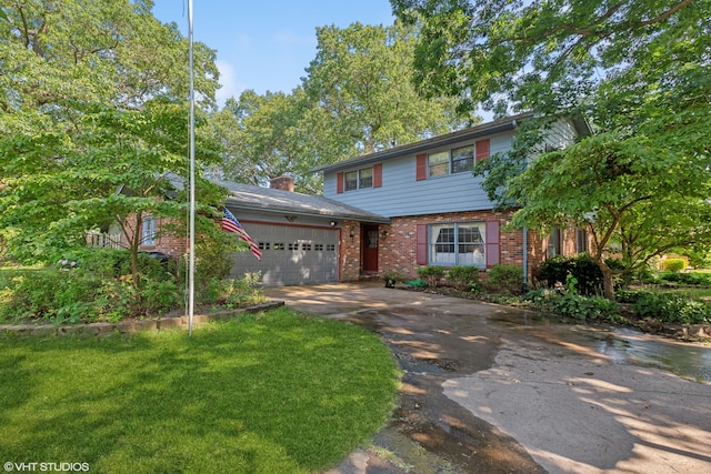 view of front facade with a front yard and a garage