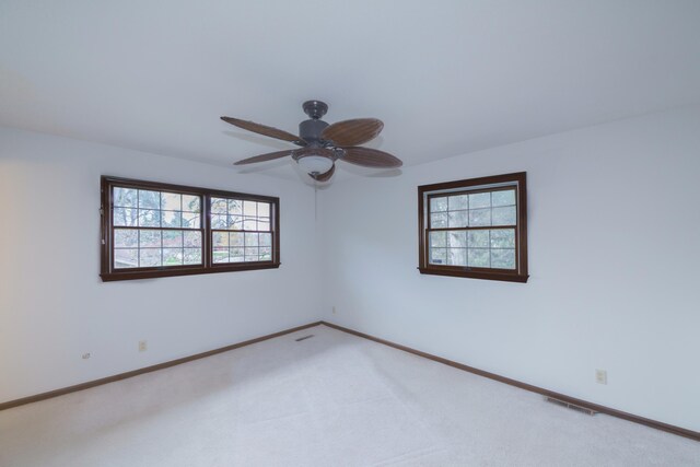 884 Oakridge Dr, Saint Joseph, MI 49085 - unfurnished room featuring a ceiling fan, carpet floors, and a healthy amount of sunlight
