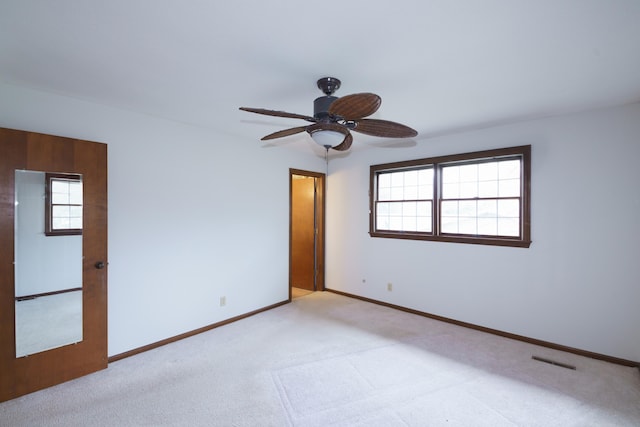 884 Oakridge Dr, Saint Joseph, MI 49085 - carpeted spare room featuring a ceiling fan, baseboards, and a healthy amount of sunlight