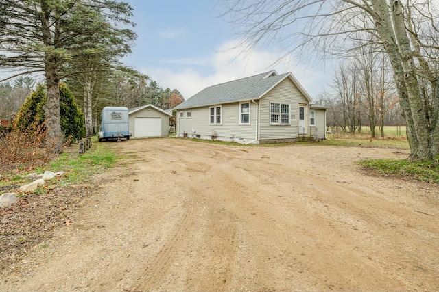 view of front of property featuring an outbuilding and a garage