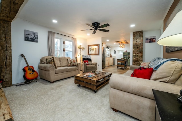 living room featuring light hardwood / wood-style floors and ceiling fan