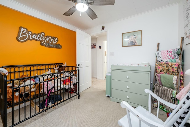 carpeted bedroom featuring ceiling fan and ornamental molding