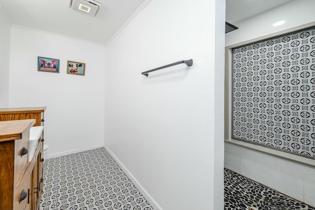 bathroom with walk in shower, vanity, and ornamental molding