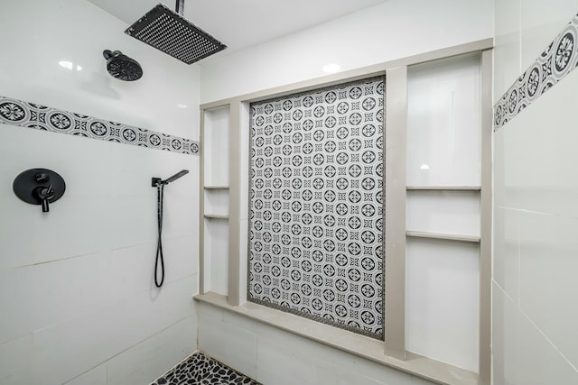 bathroom with tiled shower