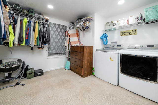 laundry room featuring independent washer and dryer and light carpet