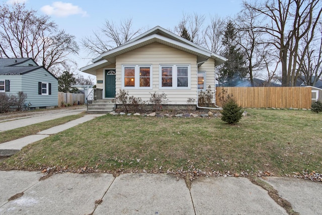 bungalow-style home featuring a front lawn