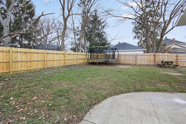 view of yard with a patio and a trampoline