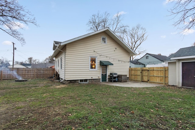 rear view of property featuring a yard and a patio