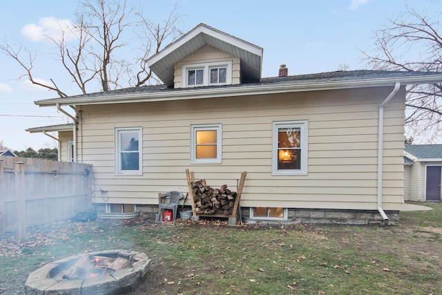 rear view of house featuring an outdoor fire pit