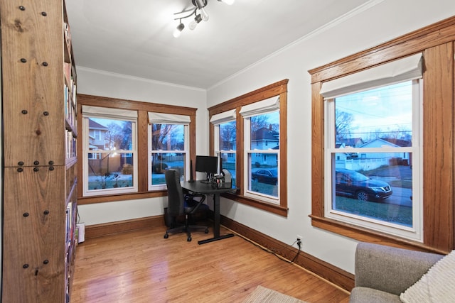 office space with light wood-type flooring and ornamental molding