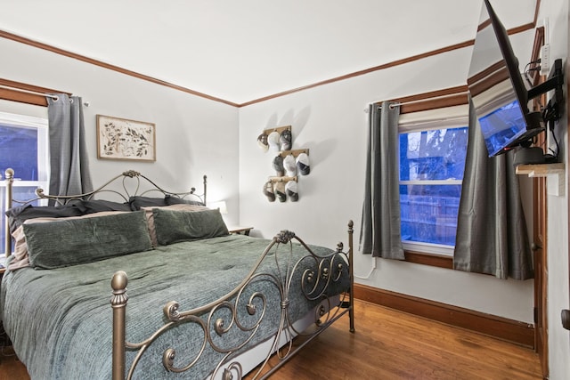 bedroom featuring ornamental molding and hardwood / wood-style flooring