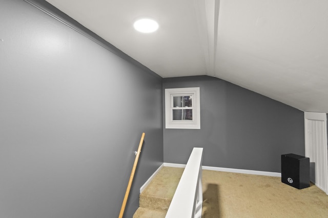 stairs with carpet flooring and lofted ceiling