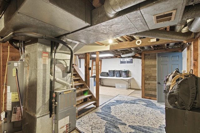 basement featuring gas water heater and heating unit