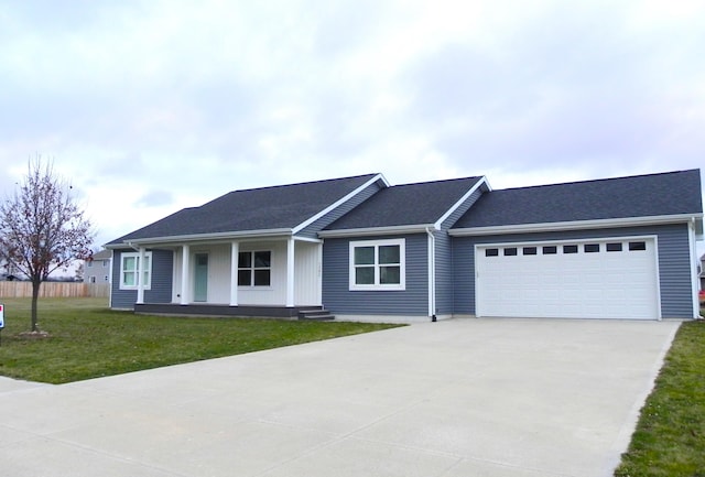 single story home with a front lawn, covered porch, and a garage