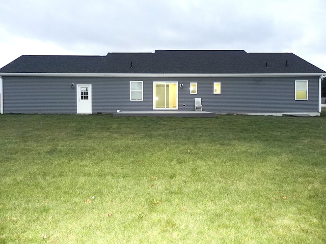 rear view of property featuring a yard