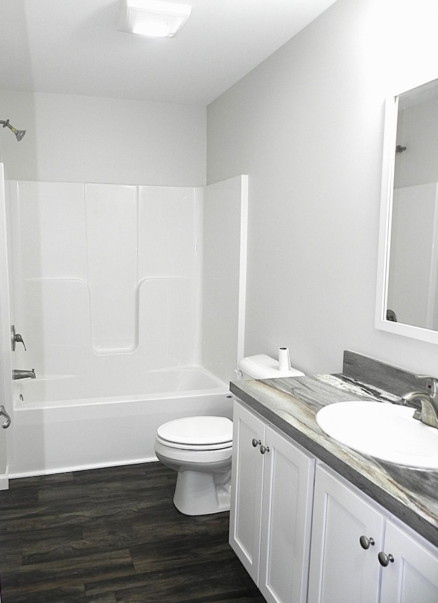 full bathroom featuring vanity, hardwood / wood-style flooring, toilet, and tub / shower combination