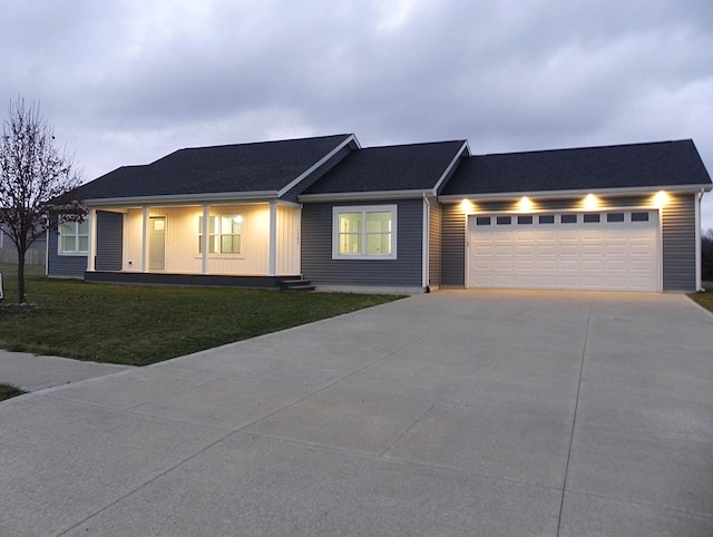 ranch-style home featuring a front lawn and a garage