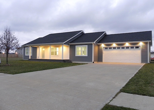 single story home featuring a garage and a front yard