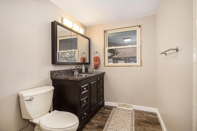 bathroom featuring hardwood / wood-style floors, vanity, and toilet