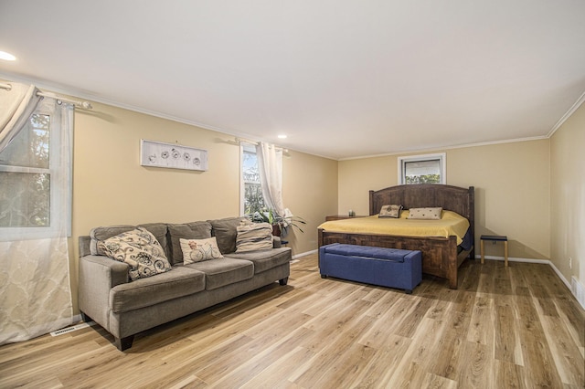 bedroom with light hardwood / wood-style floors and ornamental molding