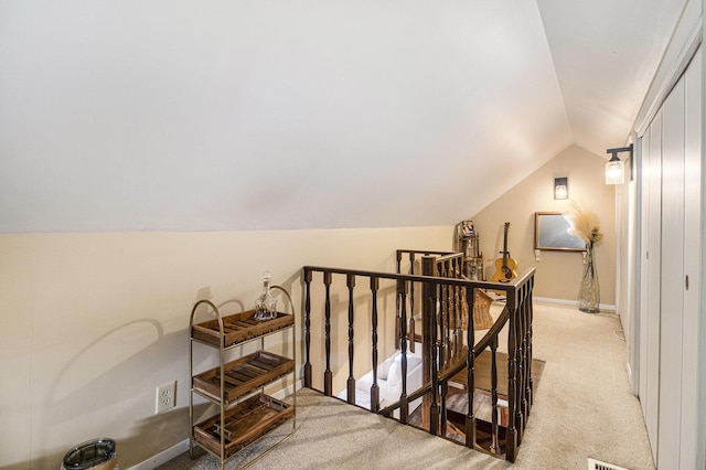 bonus room featuring light colored carpet and vaulted ceiling