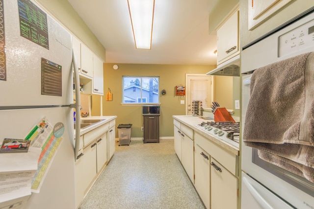 kitchen featuring white cabinetry and white appliances