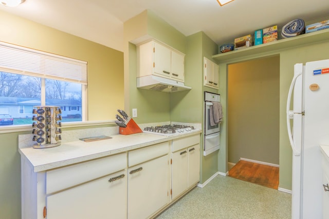 kitchen with white cabinetry and white appliances