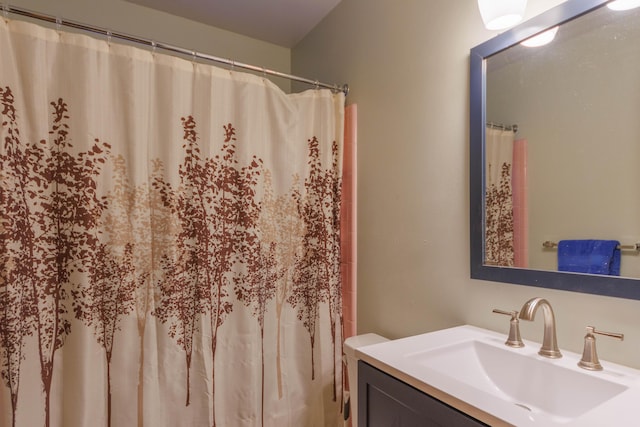 bathroom featuring vanity, a shower with shower curtain, and toilet