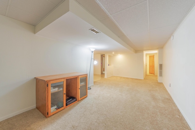 basement featuring light carpet