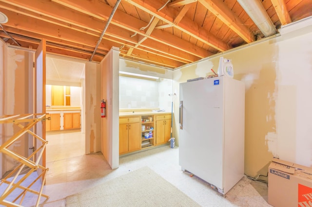 basement featuring white fridge