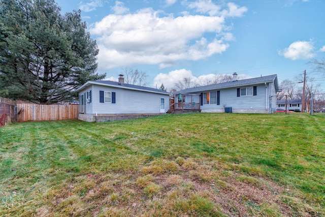 back of house with a yard and central AC unit