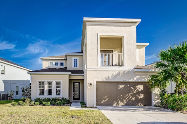 view of front of property with a garage and a front lawn