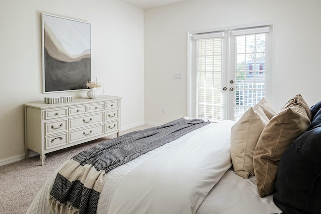 bedroom featuring access to exterior and light carpet