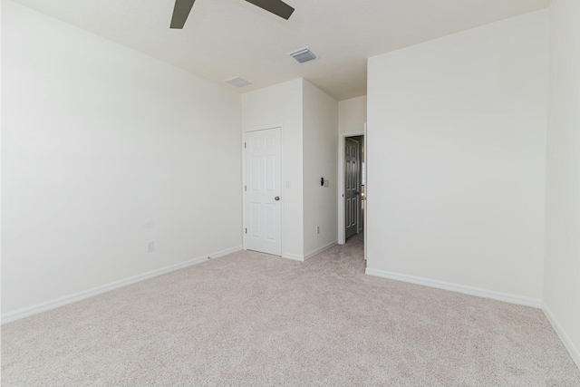 carpeted spare room featuring ceiling fan