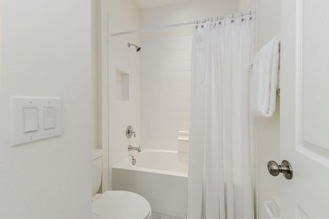 bathroom with shower / bath combo and toilet