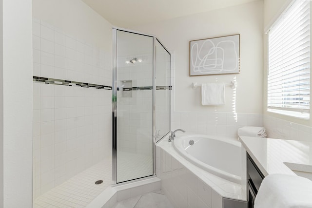 bathroom with tile patterned flooring, vanity, and plus walk in shower