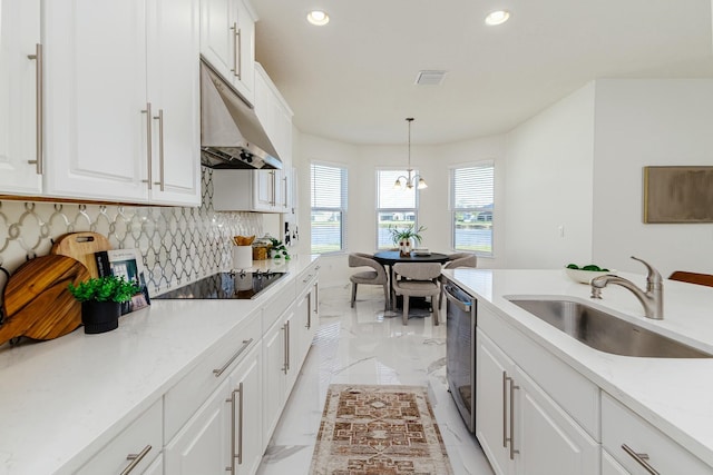 kitchen with dishwasher, black electric stovetop, sink, decorative light fixtures, and white cabinetry