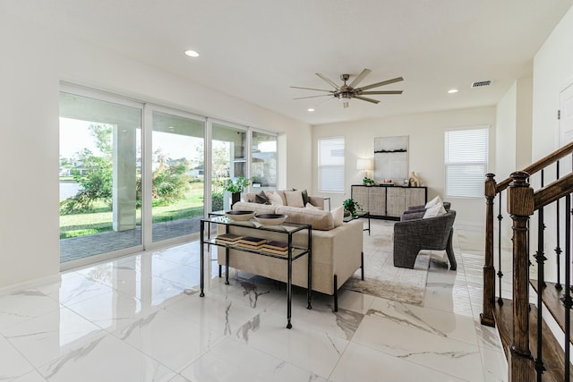 living room with ceiling fan and a wealth of natural light