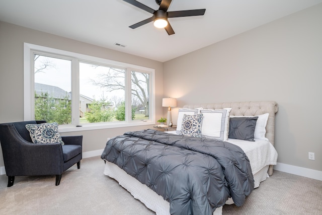 carpeted bedroom with ceiling fan and multiple windows