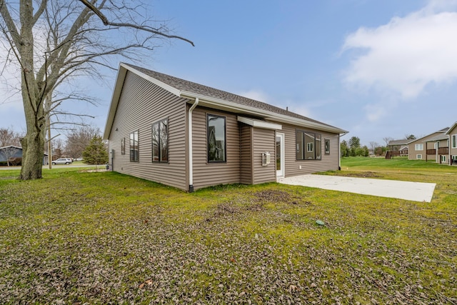 rear view of house with a patio area and a yard