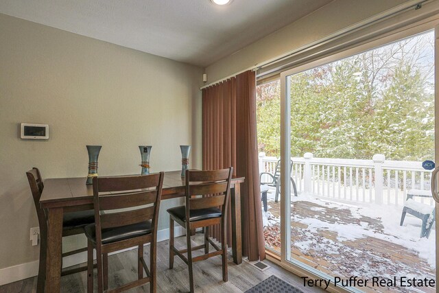 dining area with hardwood / wood-style floors