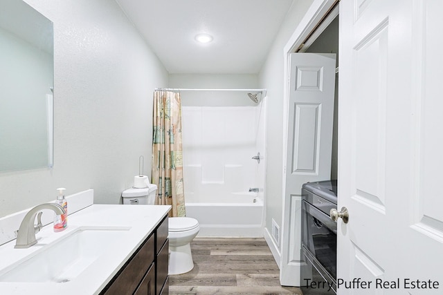 full bathroom with vanity, shower / bathtub combination with curtain, wood-type flooring, and toilet